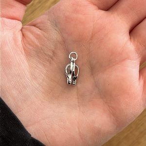 Tiny silver flip flops charm.